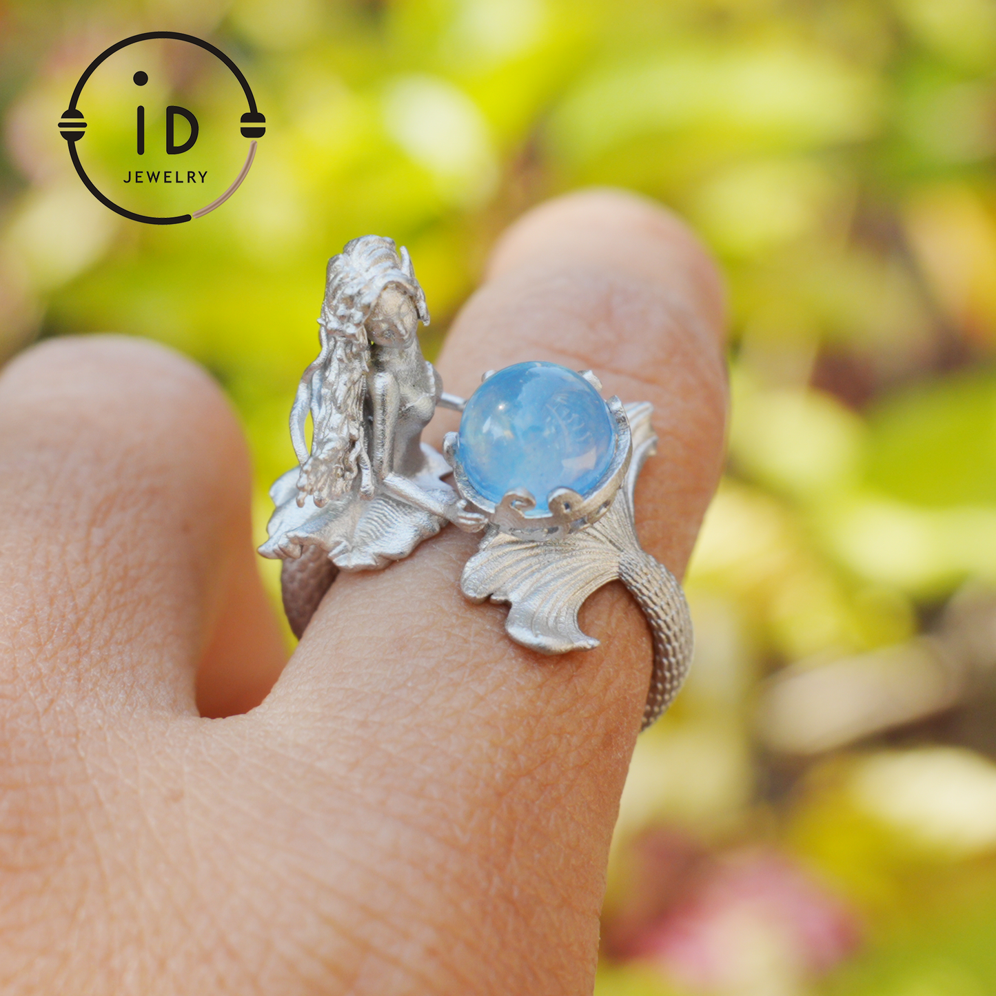 Handmade silver ring with seated mermaid and aquamarine stone, symbolic fantasy jewelry gift for women and ocean-inspired fairytale lovers